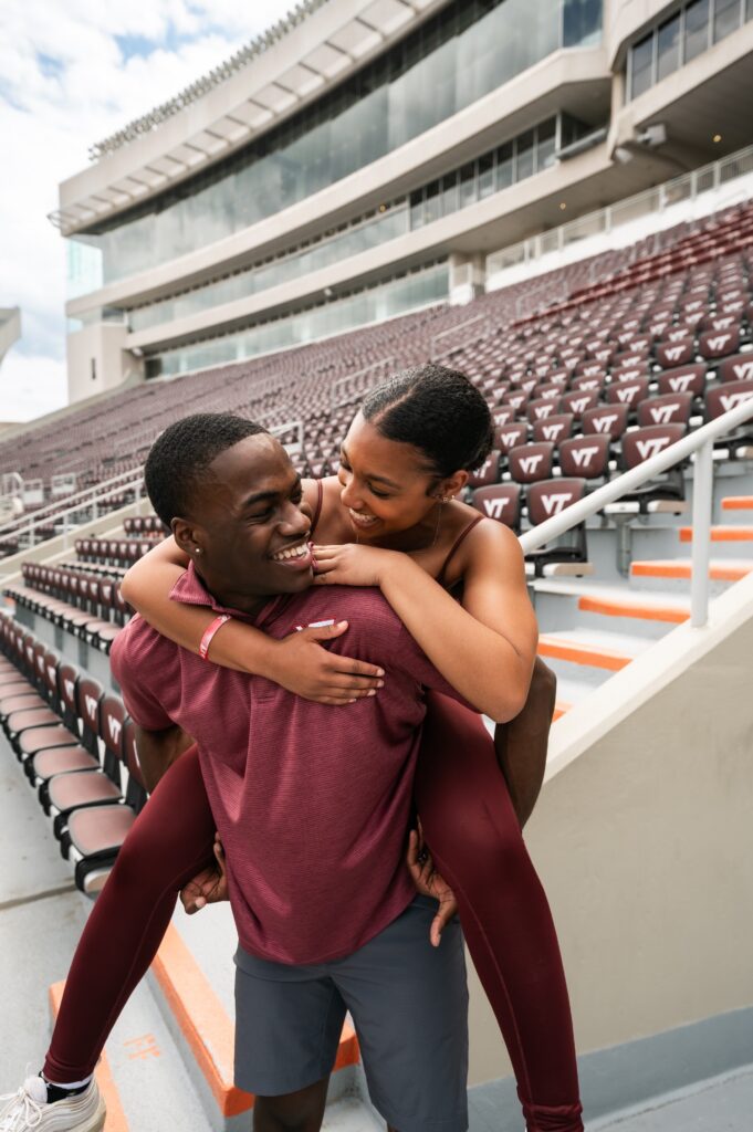 Boy posed giving friend a piggy back ride at Lane Stadium