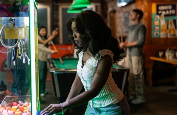 Girl playing claw machine game at a bar near Virginia Tech