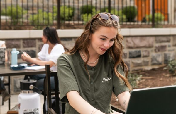 Girl studying on her laptop on the student union patio