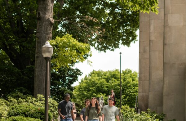 Group of Virginia Tech students walking down the steps by The Pylons
