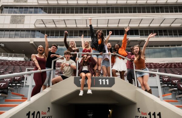 Group of friends cheering on the Hokies at Lane Stadium