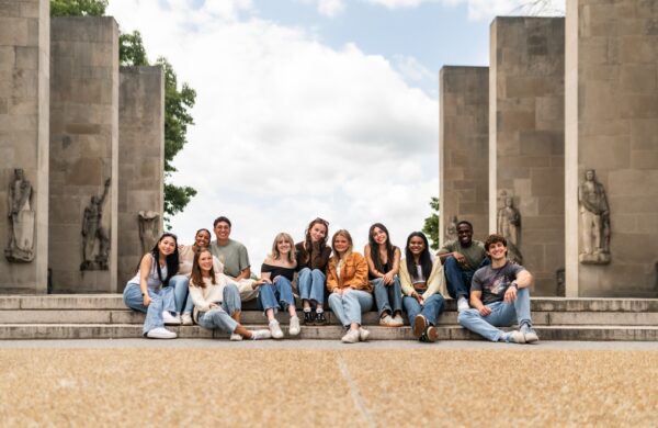 Group of friends posing on the steps of The Pylons