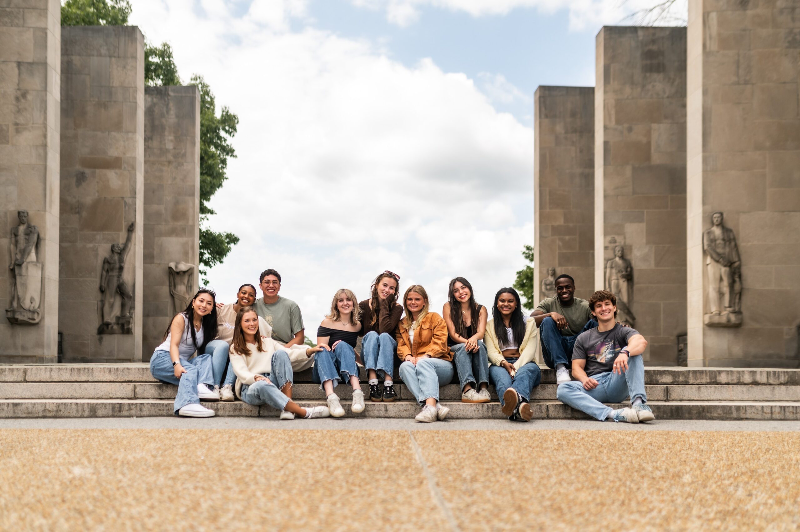 Group of friends posing on the steps of The Pylons scaled