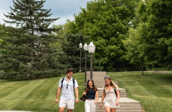 Three friends walking down steps on the Virginia Tech campus