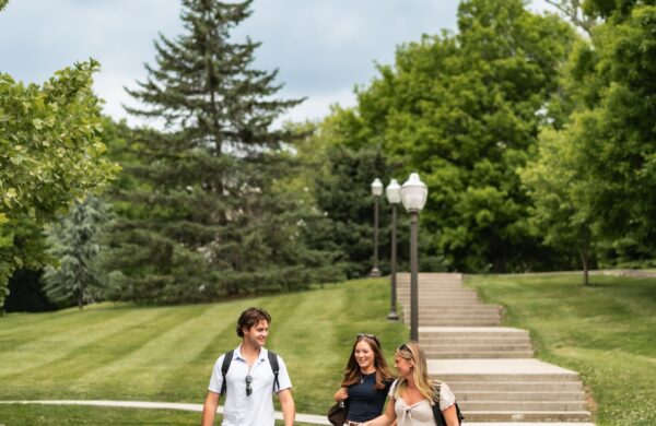 Three friends walking down the steps on the Virginia Tech campus