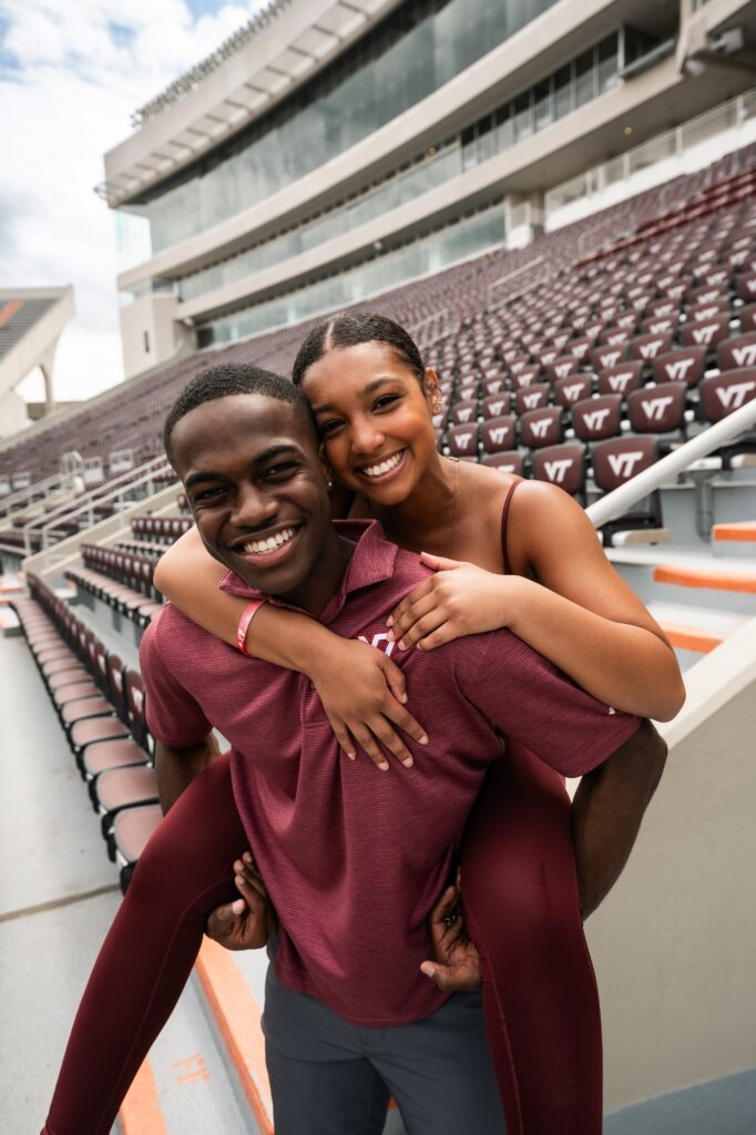 Two friends posing for a photo at Lane Stadium