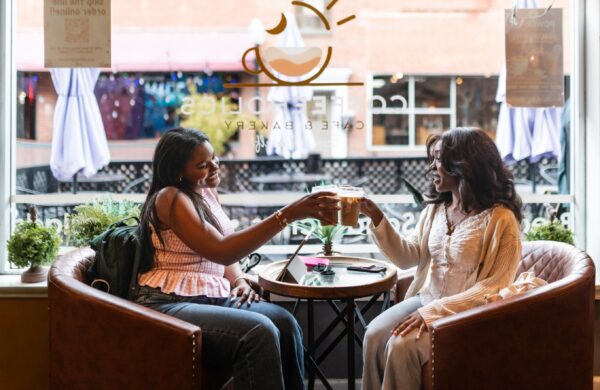 Two girl friends having coffee at a cafe near Heyday Blacksburg