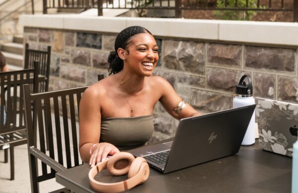 Young woman studying on the patio outside the student union
